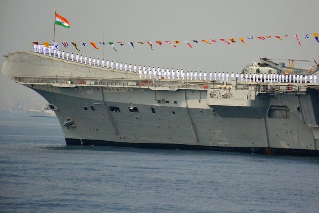 Indian Navy personnel stand on the INS Viraat, a centaur-class aircraft carrier, during the International Fleet Review in Visakhapatnam