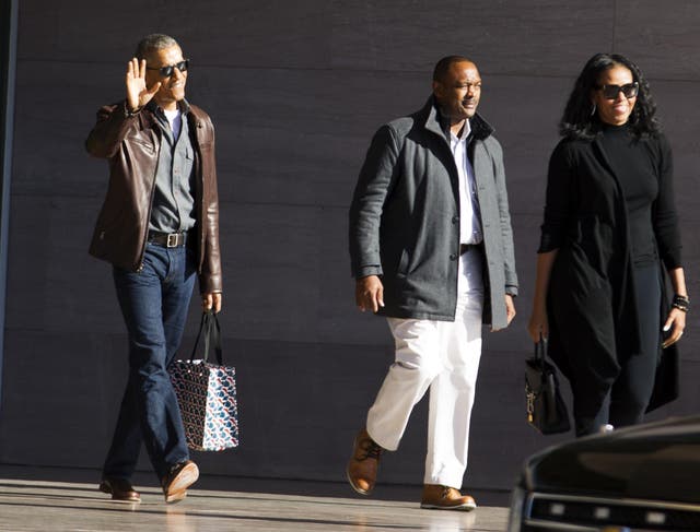 Obama wearing a brown leather jacket after leaving the National Gallery of Art in Washington, DC.