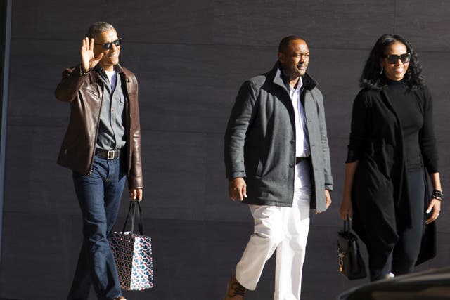 Obama wearing a brown leather jacket after leaving the National Gallery of Art in Washington, DC.