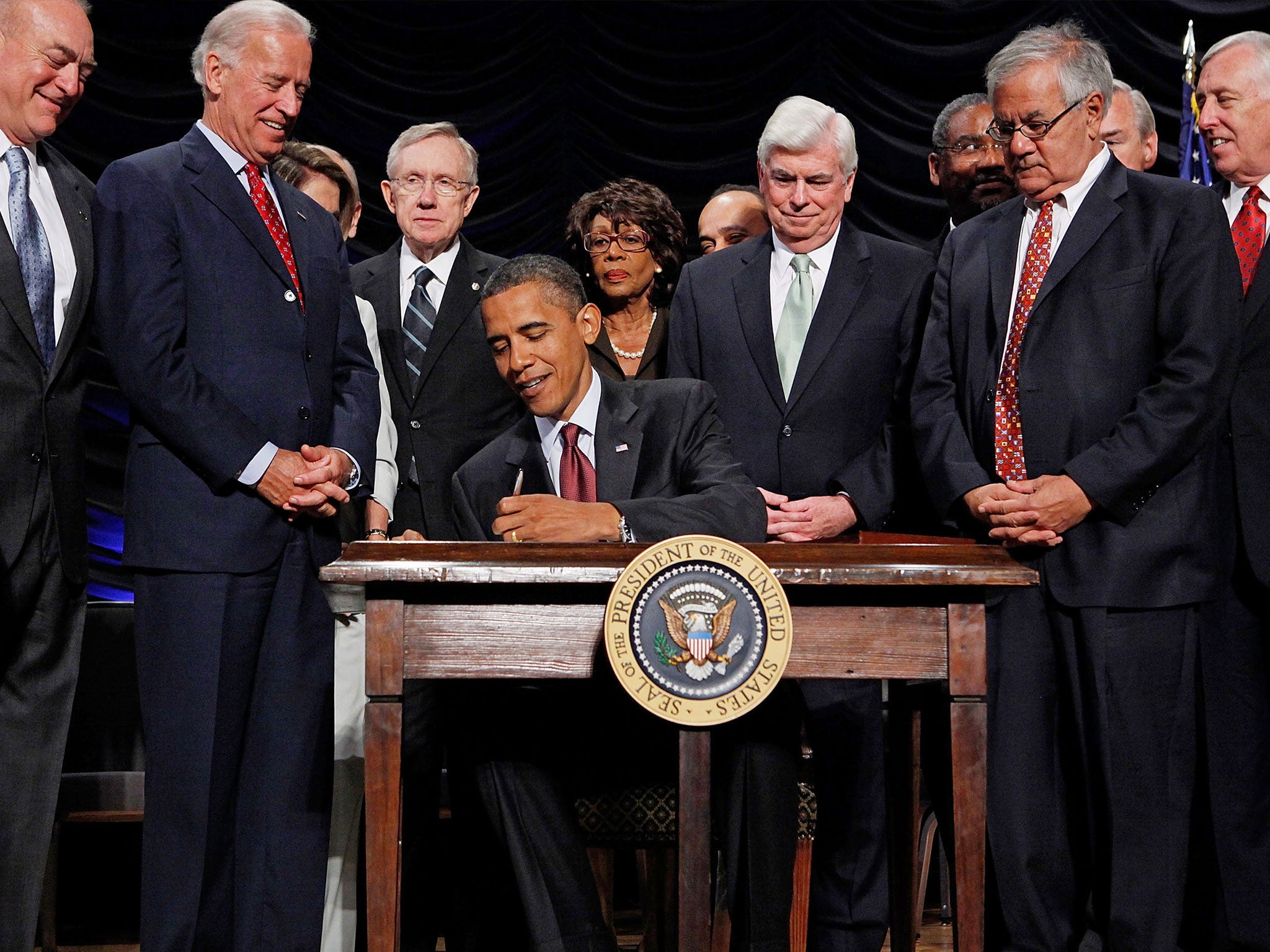 &#13;
President Obama signs the the financial reform bill into law in 2010 &#13;