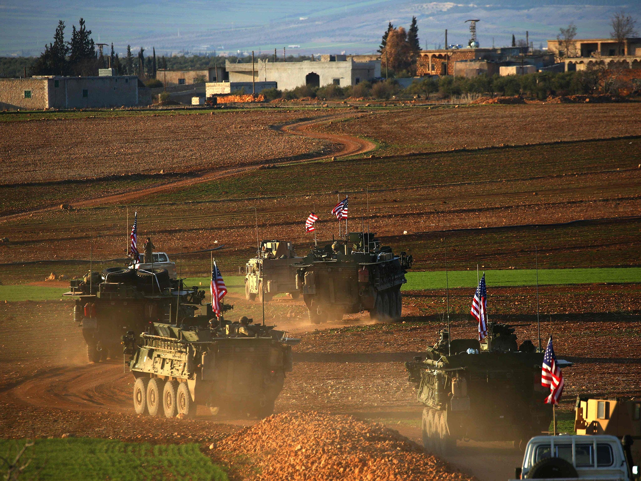 A convoy of US forces armoured vehicles drives near the village of Yalanli, on the western outskirts of the northern Syrian city of Manbij, on March 5, 2017