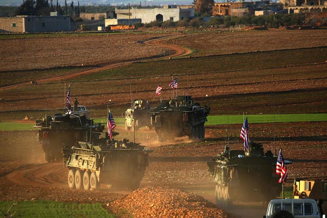 A convoy of US forces armoured vehicles drives near the village of Yalanli, on the western outskirts of the northern Syrian city of Manbij