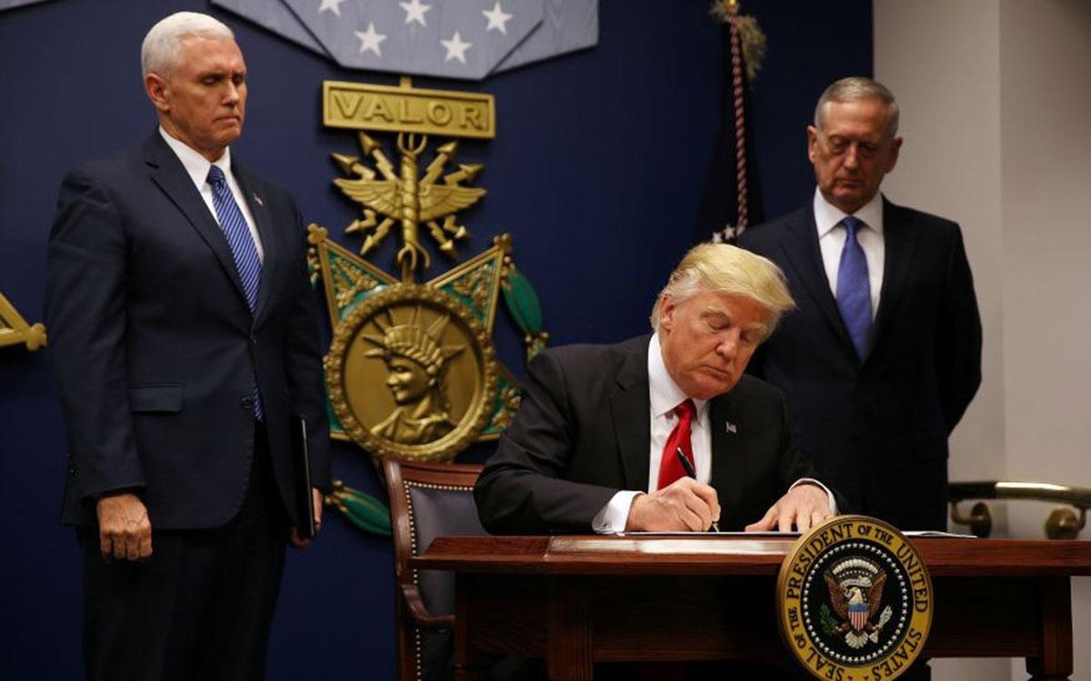 President Trump with Vice President Mike Pence (left) and James Mattis as he signs new order