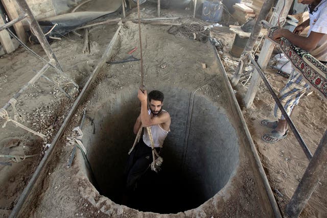 A Palestinian man being lowered into a smuggling tunnel beneath the Gaza-Egypt border in 2013. The tunnels were destroyed by the Egyptian government  in 2014 and 2015