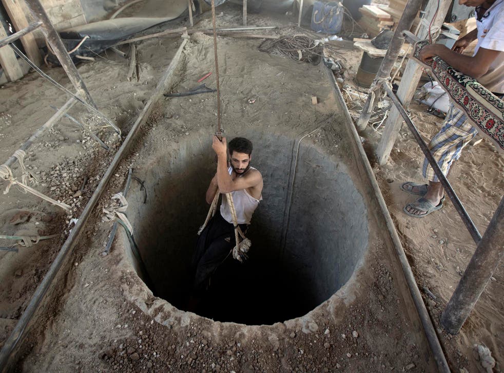 A Palestinian man being lowered into a smuggling tunnel beneath the Gaza-Egypt border in 2013. The tunnels were destroyed by the Egyptian government  in 2014 and 2015