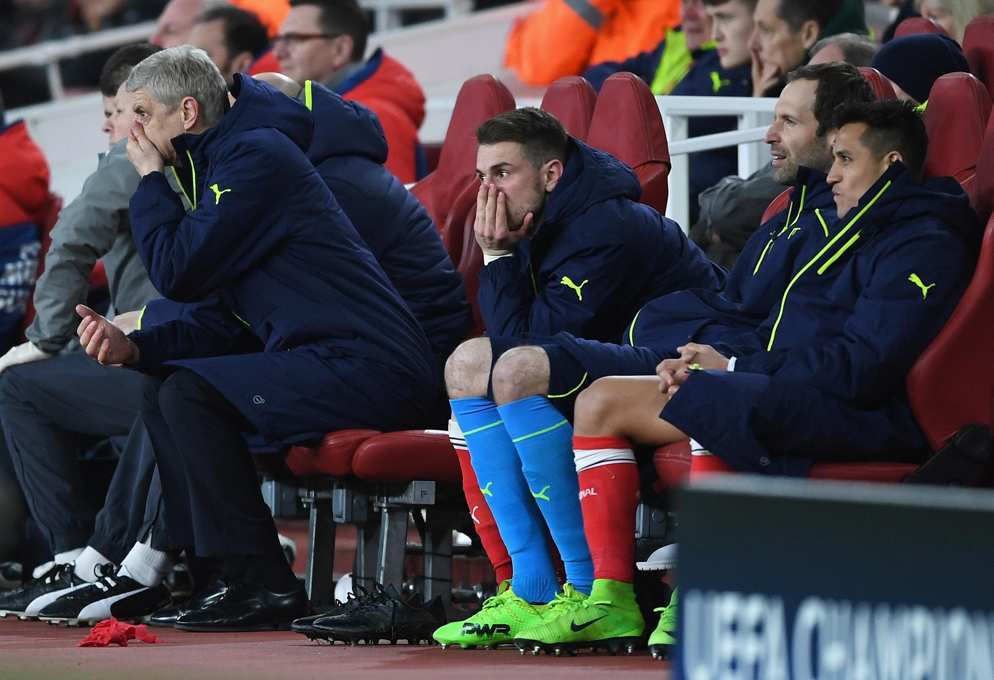 Arsene Wenger and his Arsenal players look on in disbelief during the 5-1 defeat by Bayern Munich
