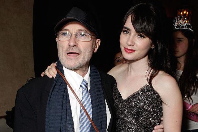 Phil Collins with his daughter, actress Lily Collins, at a party for the film Mirror Mirror in Los Angeles