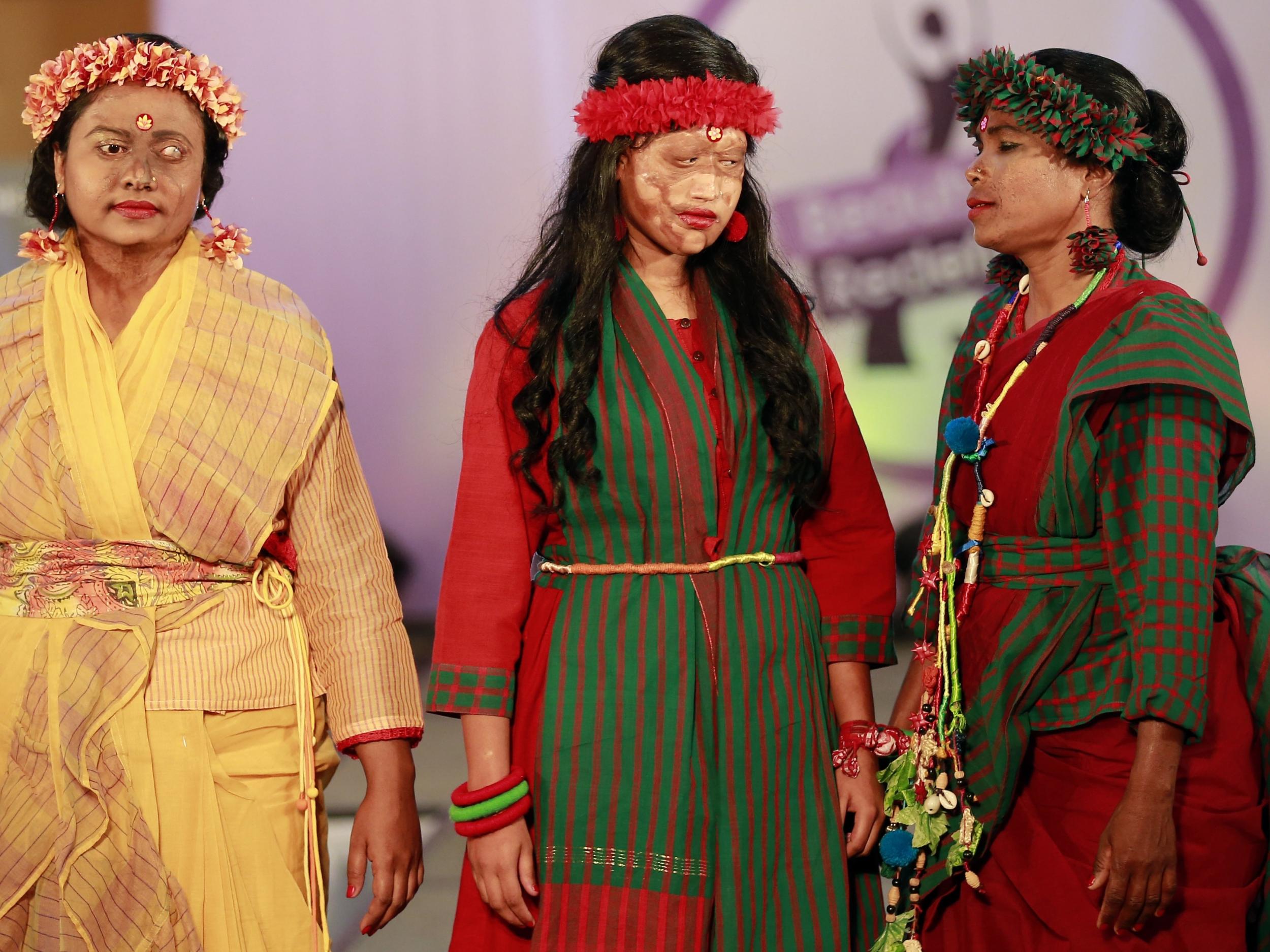 A Bangladeshi acid attack survivor walk down the catwalk during the event 'Beauty Redefined' in Dhaka