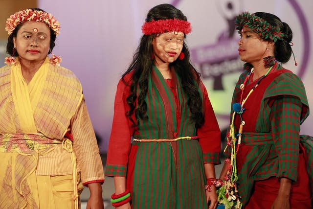 A Bangladeshi acid attack survivor walk down the catwalk during the event 'Beauty Redefined' in Dhaka