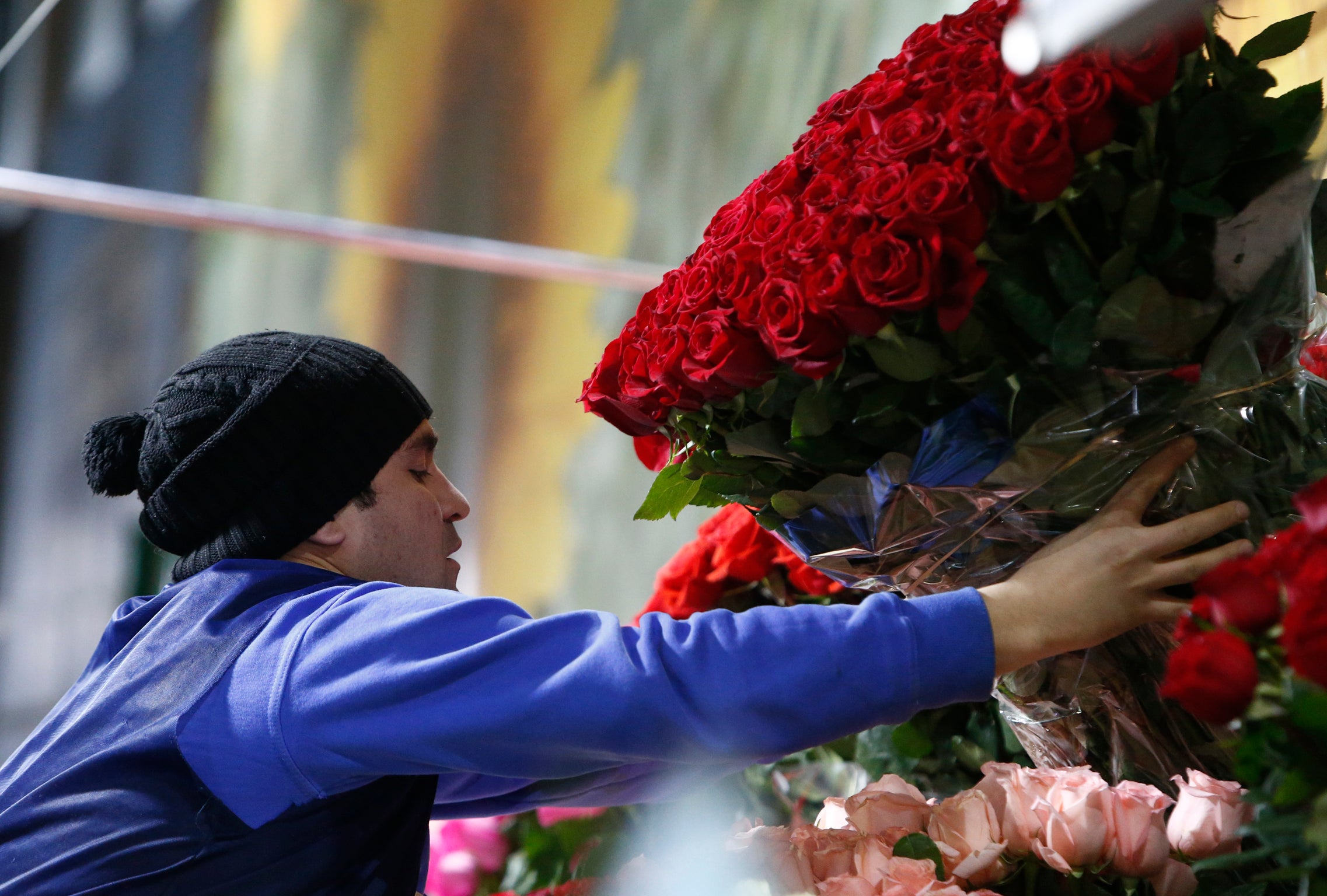 A vendor sells roses ahead of International Women's Day at the Rizhsky flower market in Moscow, Russia