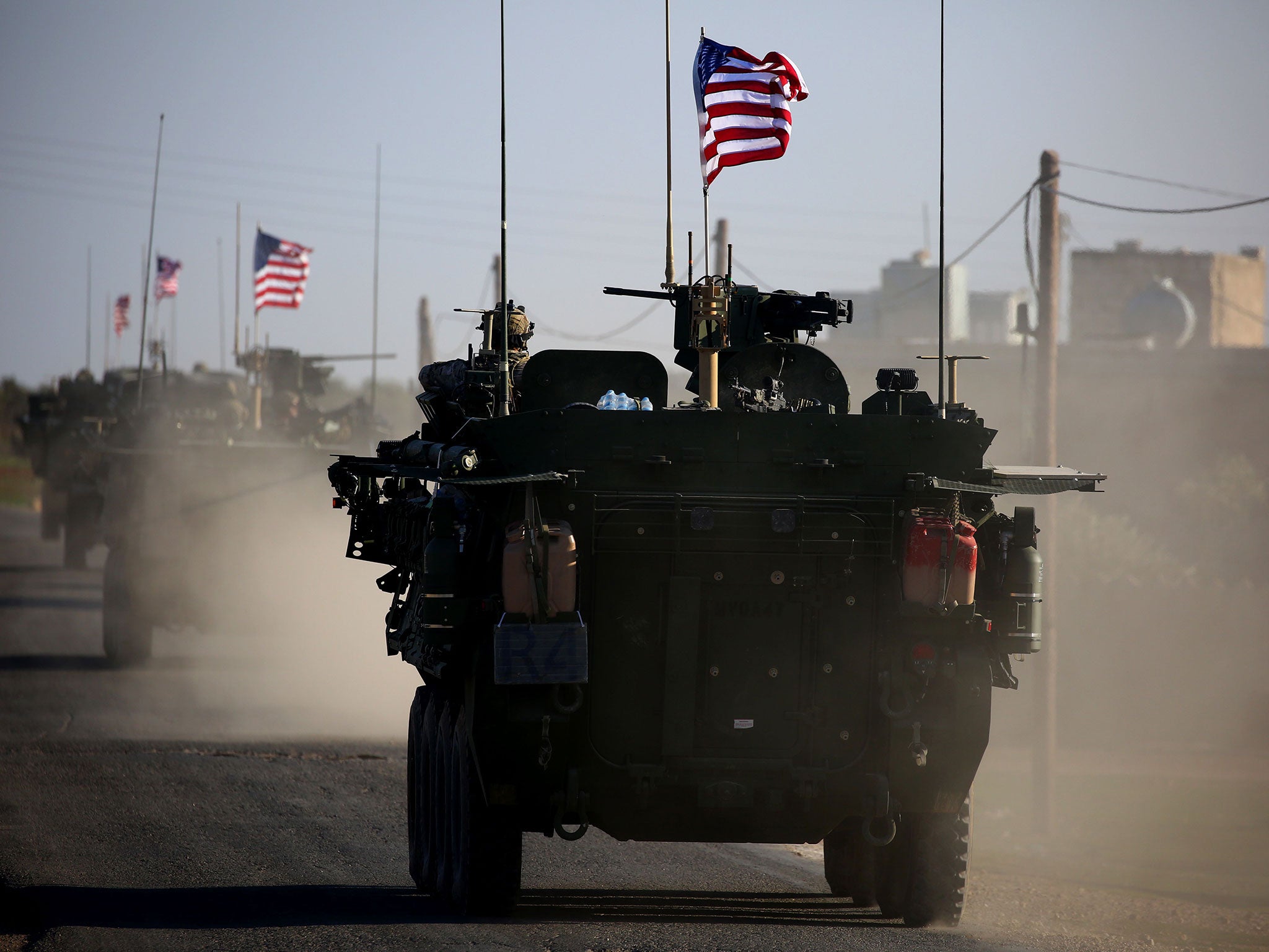 A convoy of US forces vehicles drives near the village of Yalanli, on the outskirts of the northern Syrian city of Manbij on 5 March