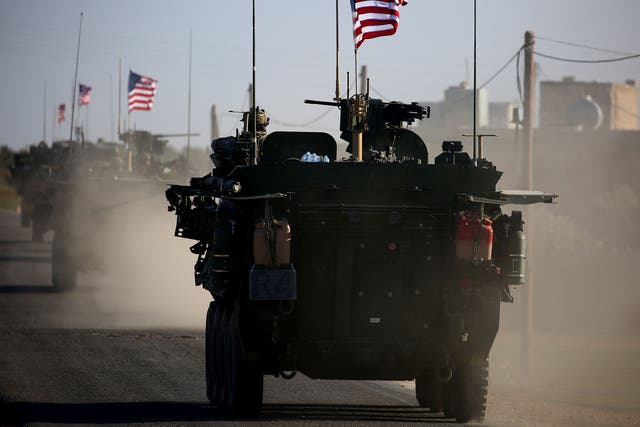A convoy of US forces vehicles drives near the village of Yalanli, on the outskirts of the northern Syrian city of Manbij on 5 March