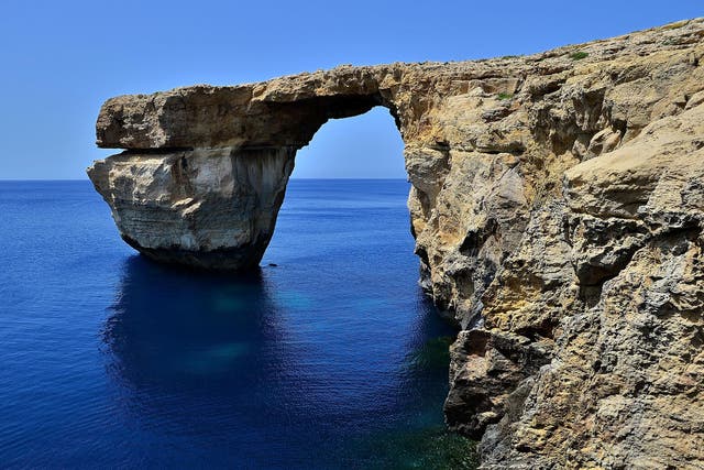 The Azure Window arched over blue seas popular with divers and featured in countless tourism brochures
