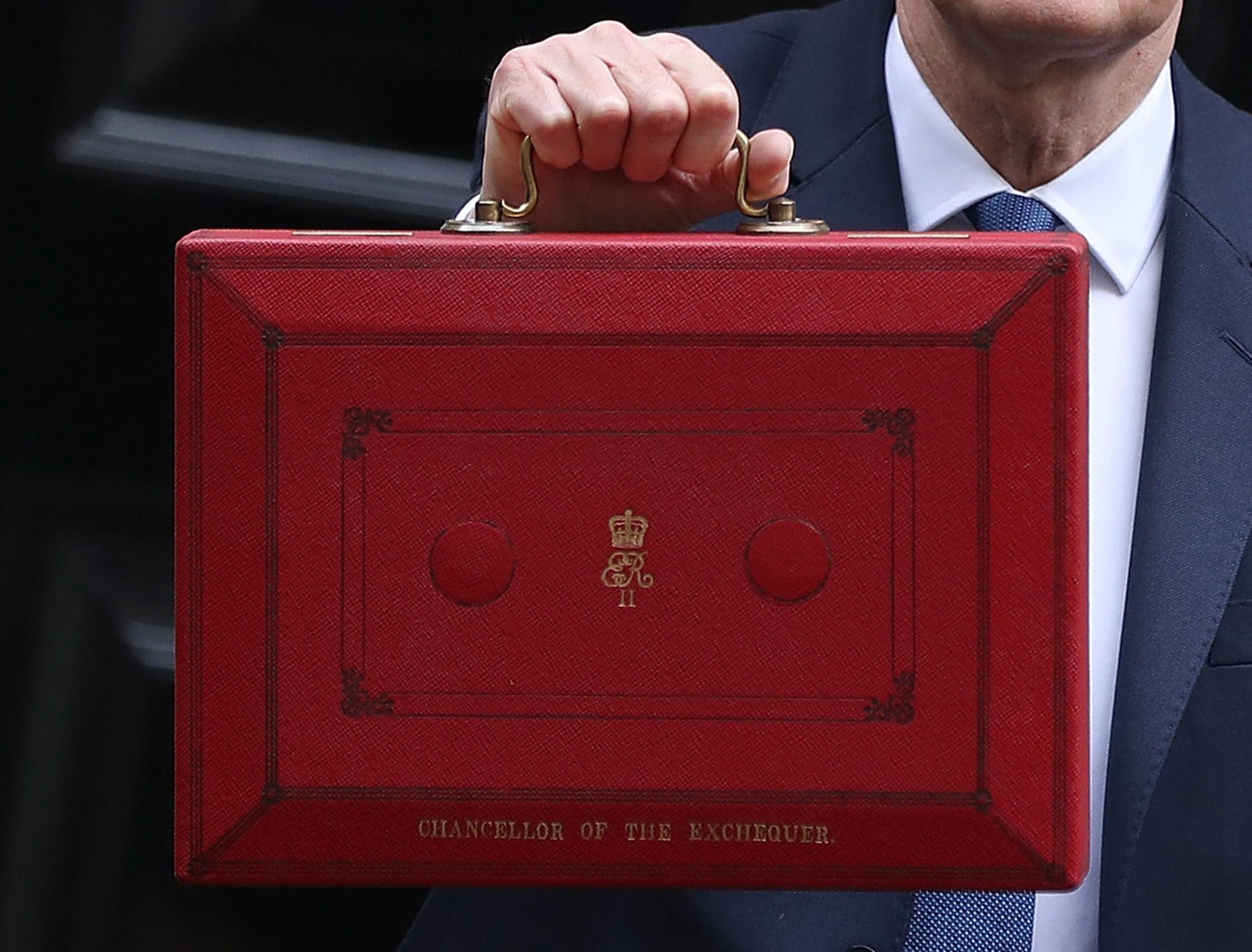 Chancellor of the Exchequer Philip Hammond holds the budget box up to the media as he leaves 11 Downing Street on March 8, 2017 in London, England