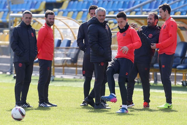 Jose Mourinho with his players as they test the pitch at the Olimp-2 Stadium