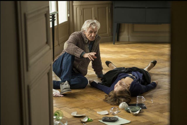 Isabelle Huppert (Michéle) lying on the floor receiving instruction from director Paul Verhoeven in 'Elle'