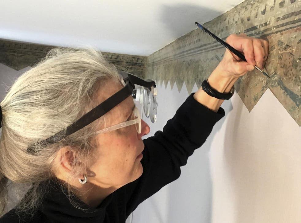 Restoration expert Margaret Saliske works on hand-painted borders at the home of artist Thomas Cole, in Catskill, New York