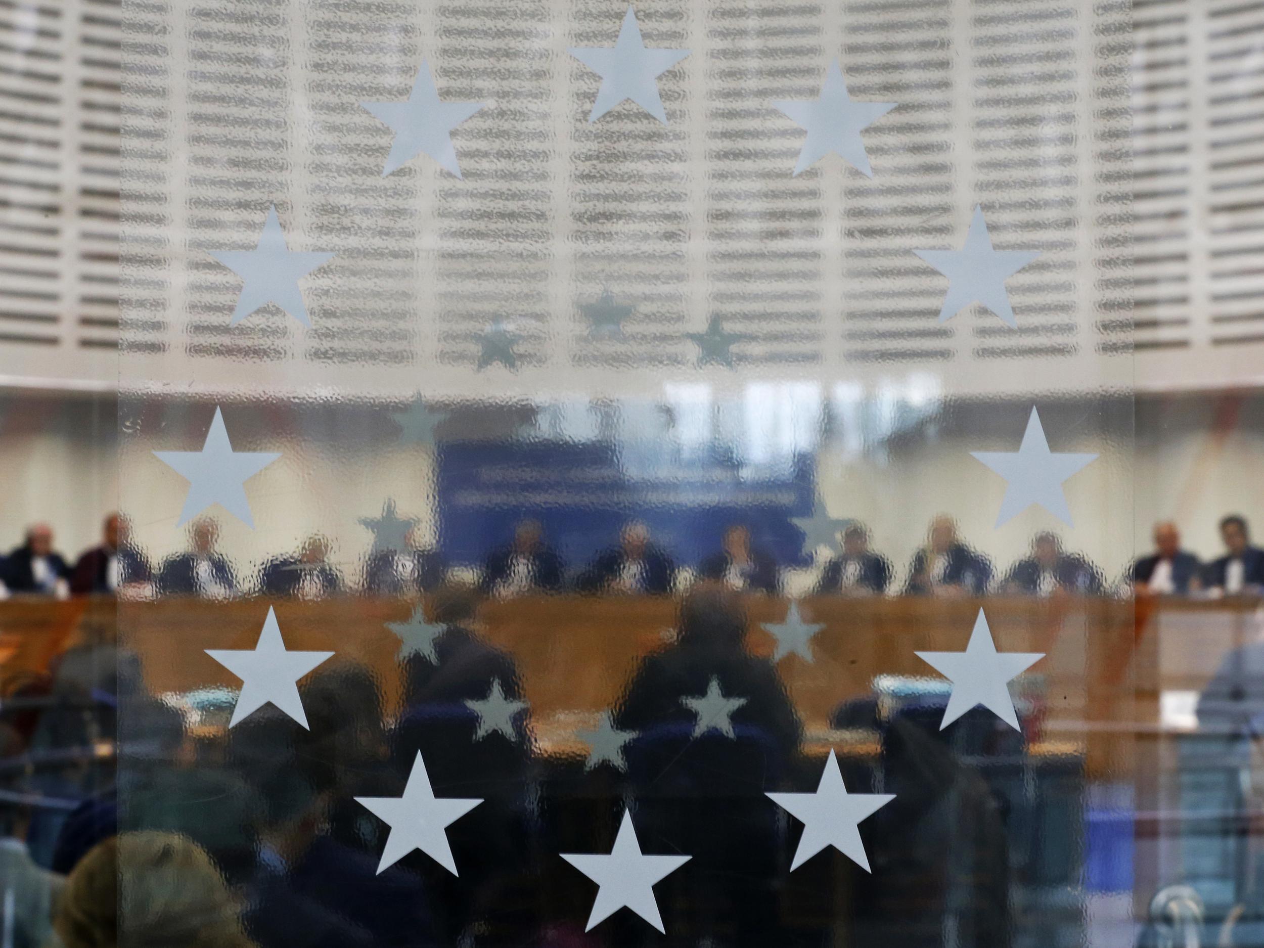 Judges of the European Court of Human Rights sit in the courtroom