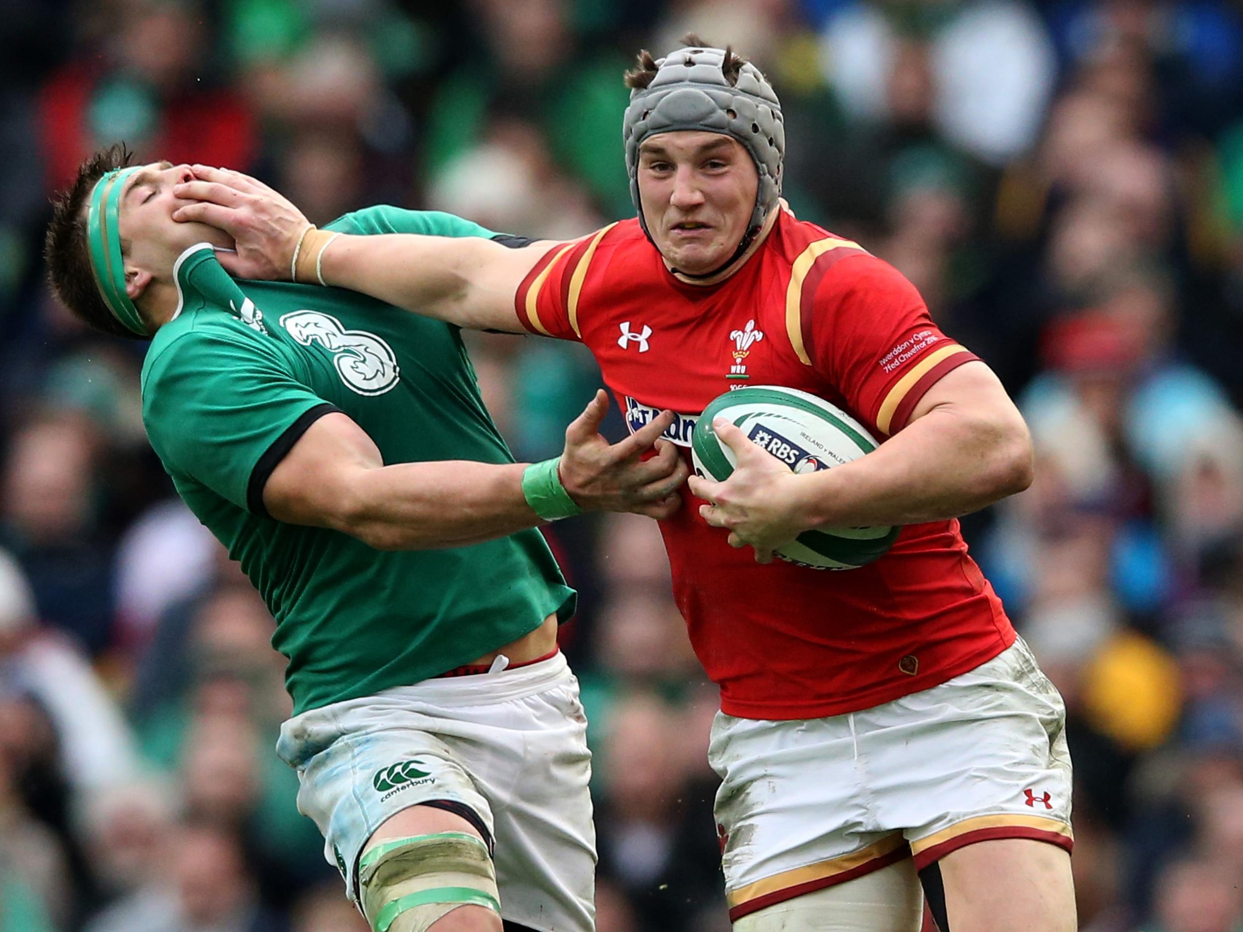 Jonathan Davies gives a big hand off to CJ Stander - both of whom will be playing on Friday night