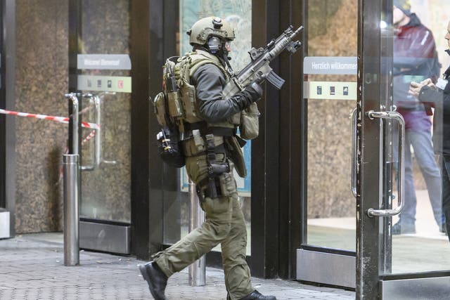 Police enter the main railway station in Dusseldorf following what police described as an axe attack