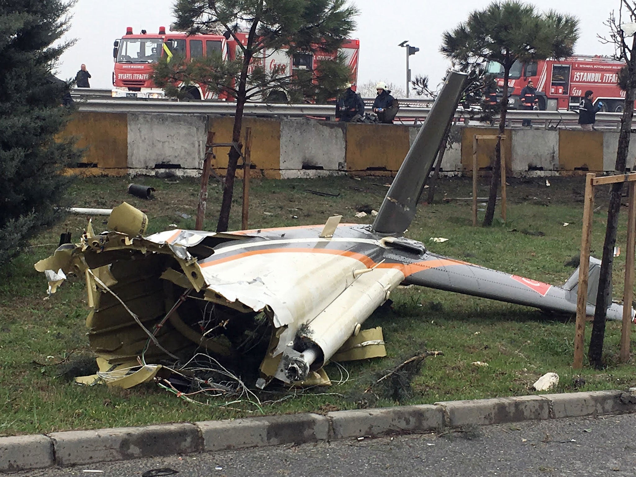 Firefighters at the scene of a helicopter crash in Istanbul's Buyukcekmece district on 10 March