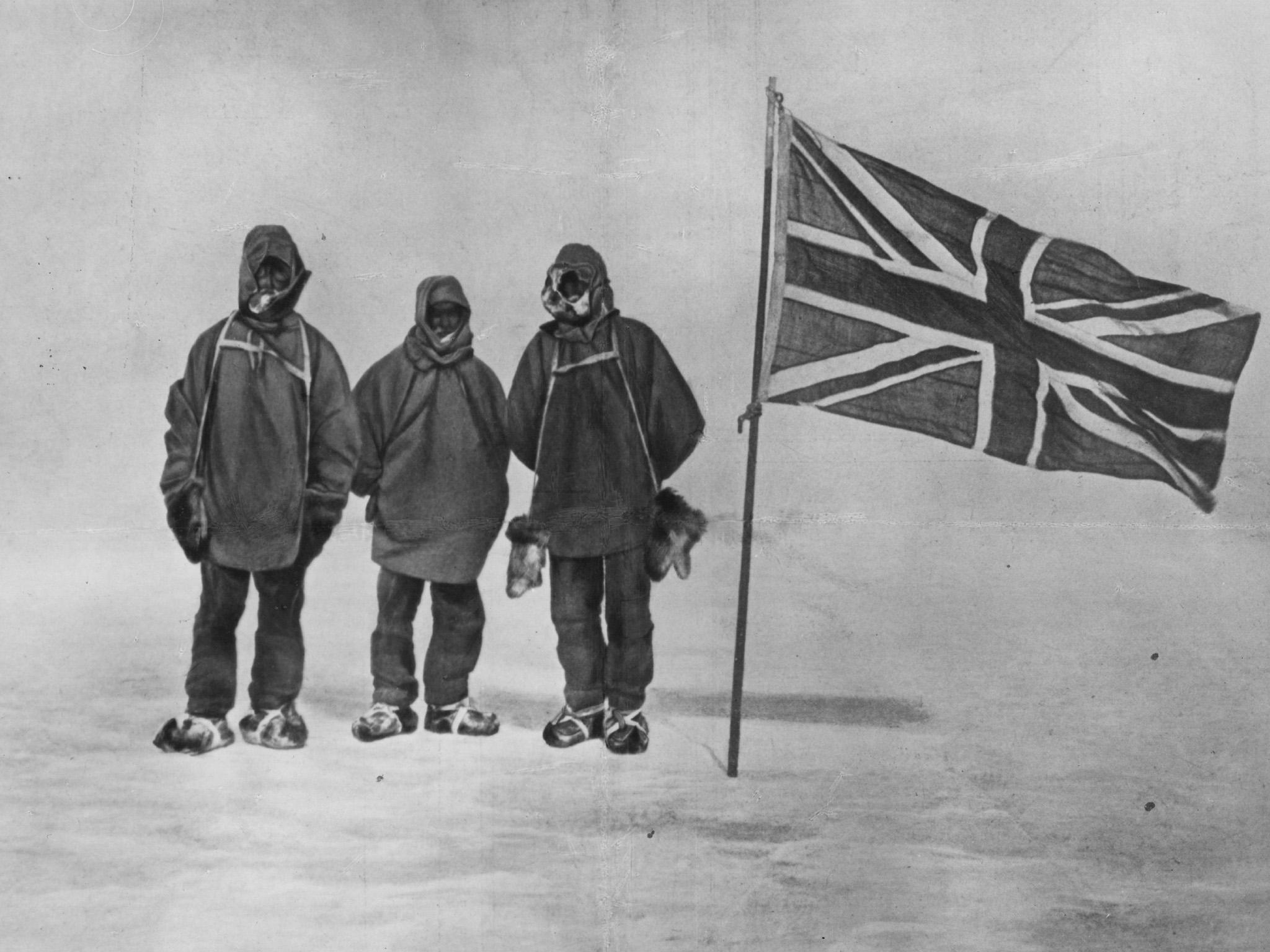 Sir Ernest Henry Shackleton and two members of his expedition team beside a Union Jack within 111 miles of the South Pole, a record feat