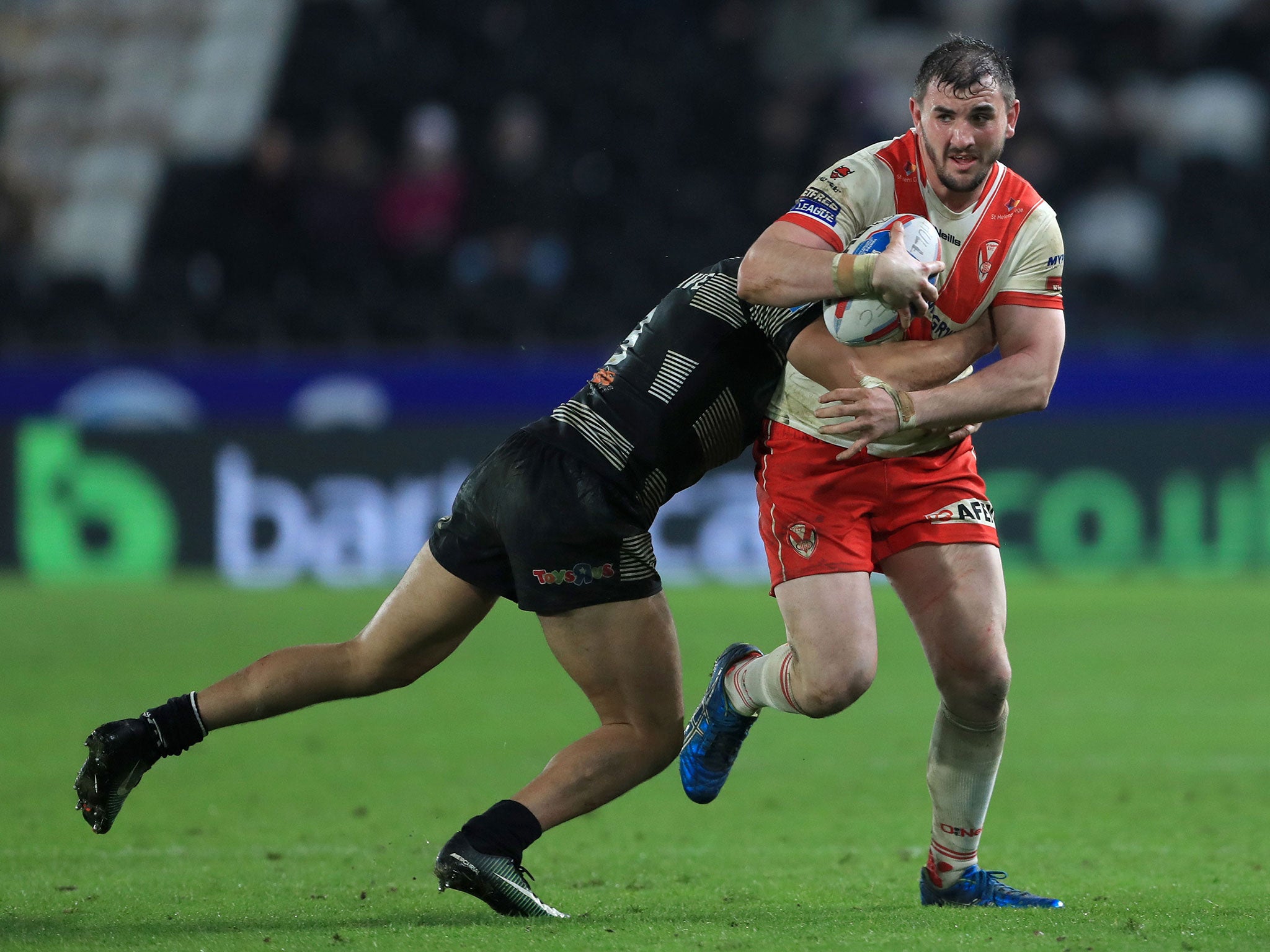 St Helens' Adam Walker (right) is tackled by Hull FC's Carlos Tuimavave