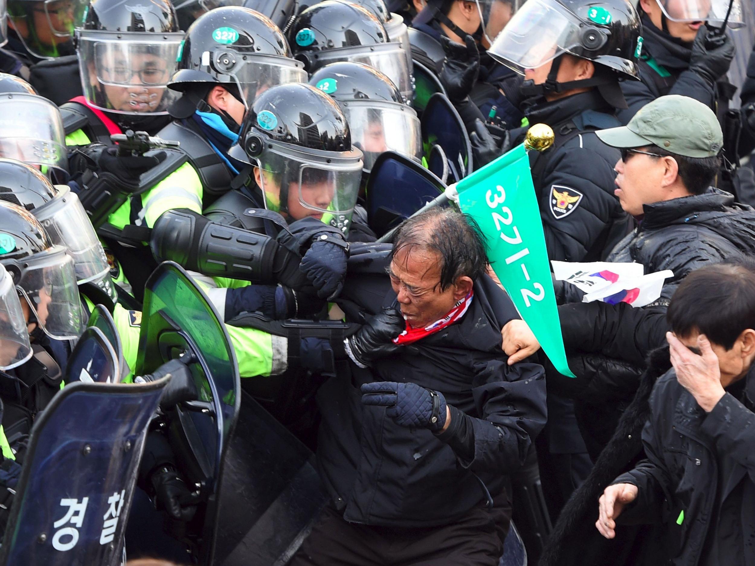 South Korean supporters of Park Geun-Hye clash with police after the announcement of the Constitutional Court ruling over her impeachment, in Seoul on 10 March, 2017
