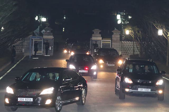 A car (L front) carrying South Korea's impeached ex-president Park Geun-Hye (C in the car) leaves the presidential Blue House in Seoul on 12 March, 2017
