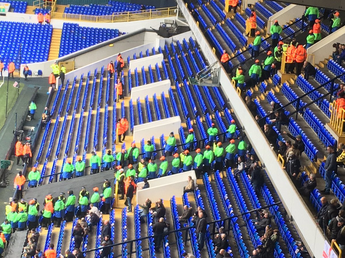 Stewards wearing plastic hard hats inside White Hart Lane (Twitter @AwayDays23)