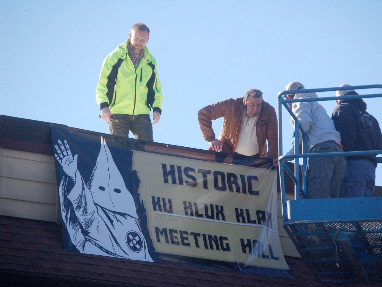 City officials take down a KKK sign from a vacant building downtown in Dahlonega, Georgia, on Feruary. 16. Residents said the banner left them both surprised and scared