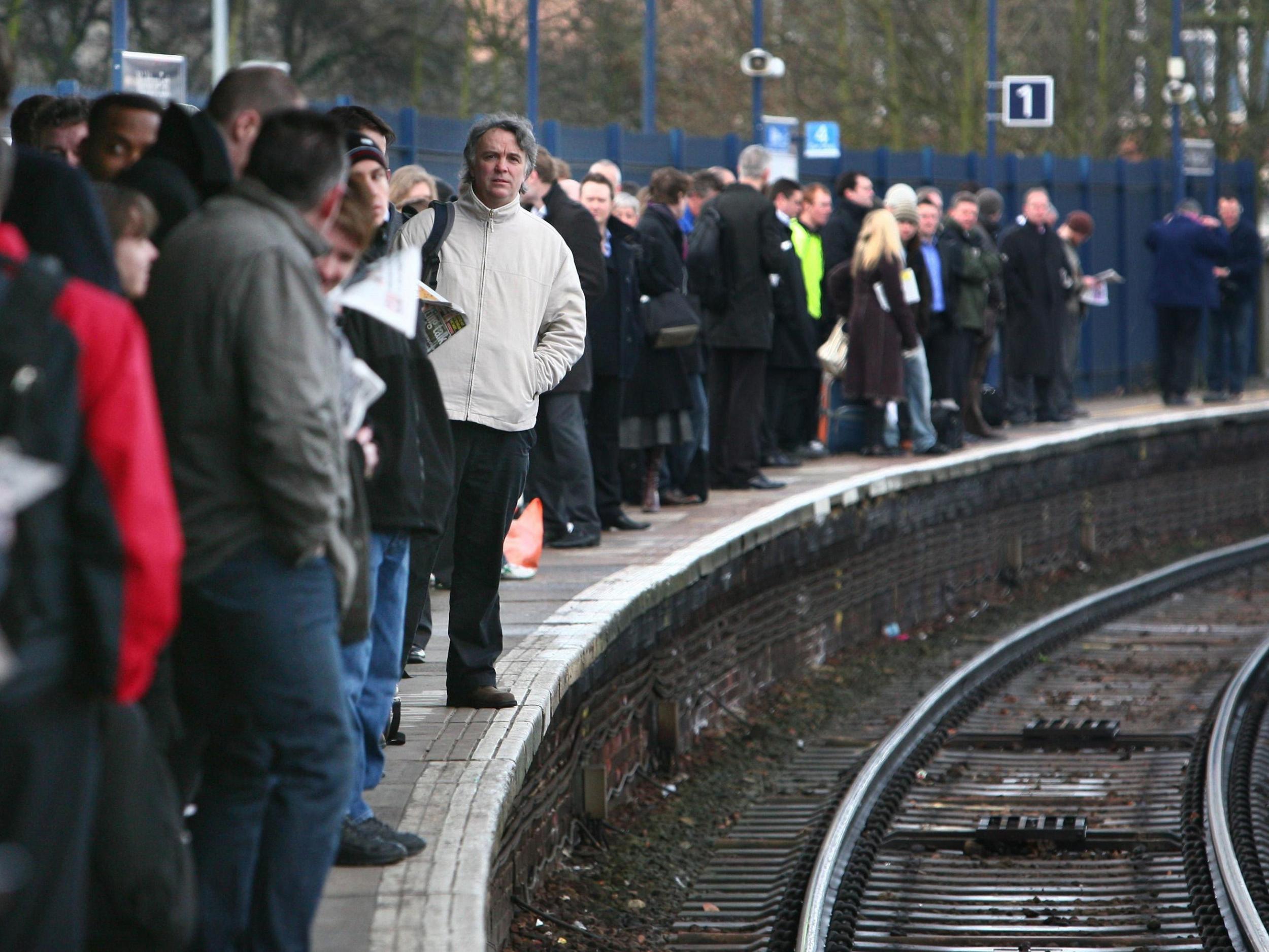 Commuters waiting on a platform as up to 2,000 workers at three rail companies will go on strike in separate disputes over staffing, threatening some of the worst disruption since the industry was privatised