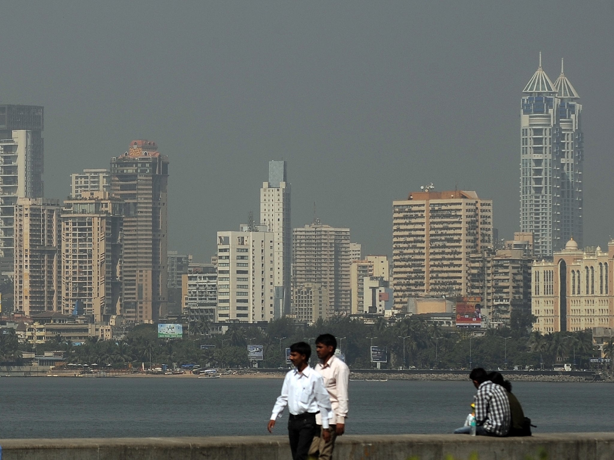 The Mumbai city skyline is seen from a seaside promenade in Mumbai