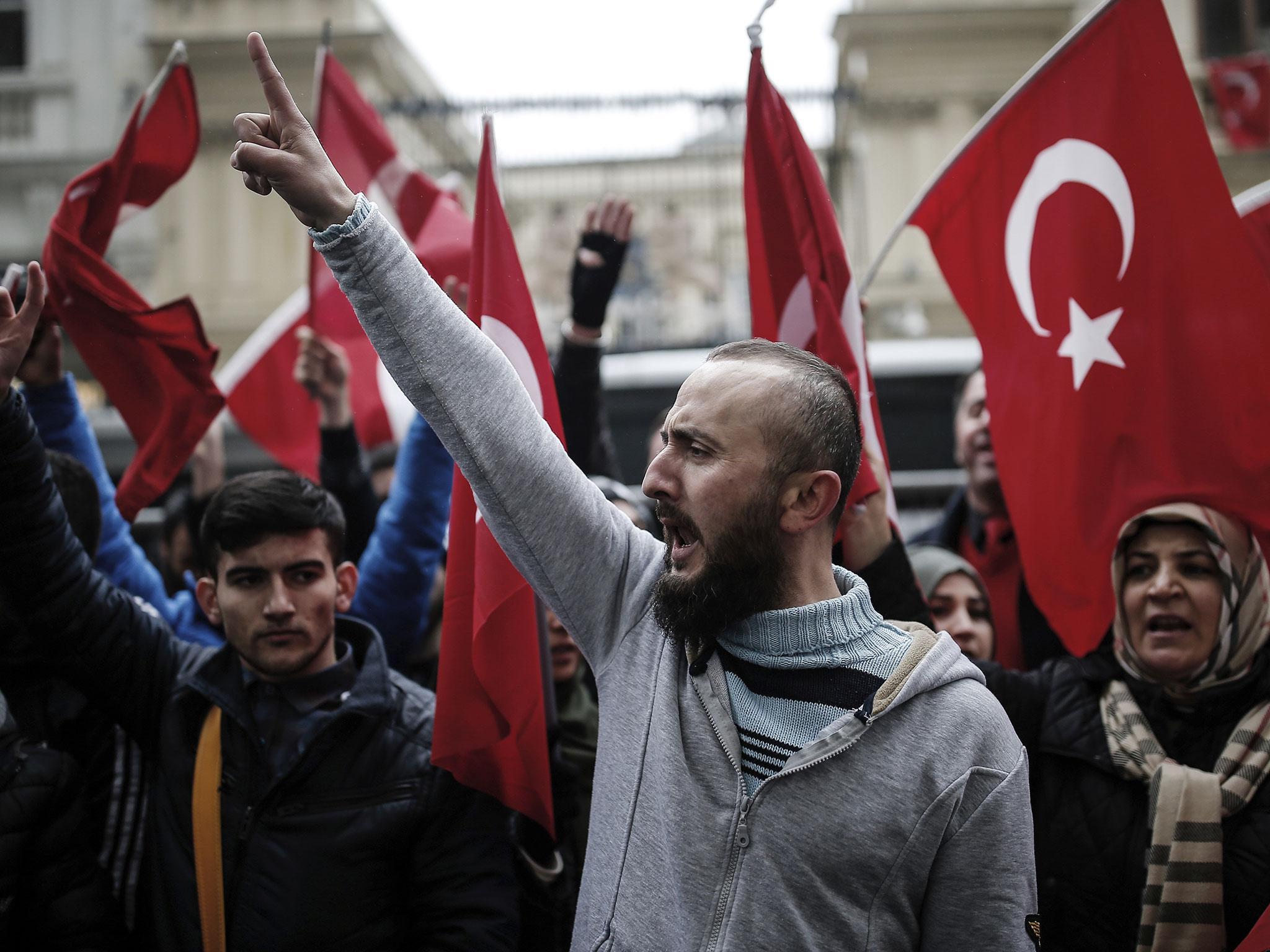 Dutch police used dogs and water cannons to disperse hundreds of protesters from outside the Turkish consulate in Rotterdam