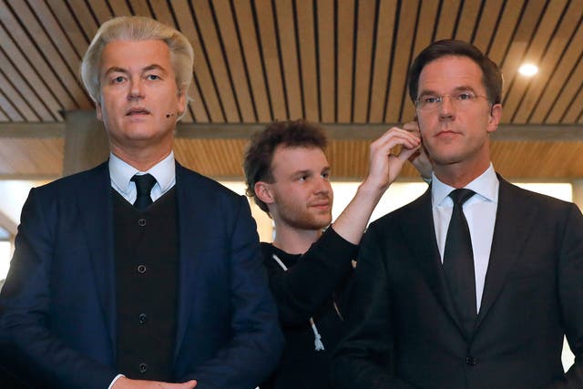 Geert Wilders and Mark Rutte get their microphones installed before the televised debate
