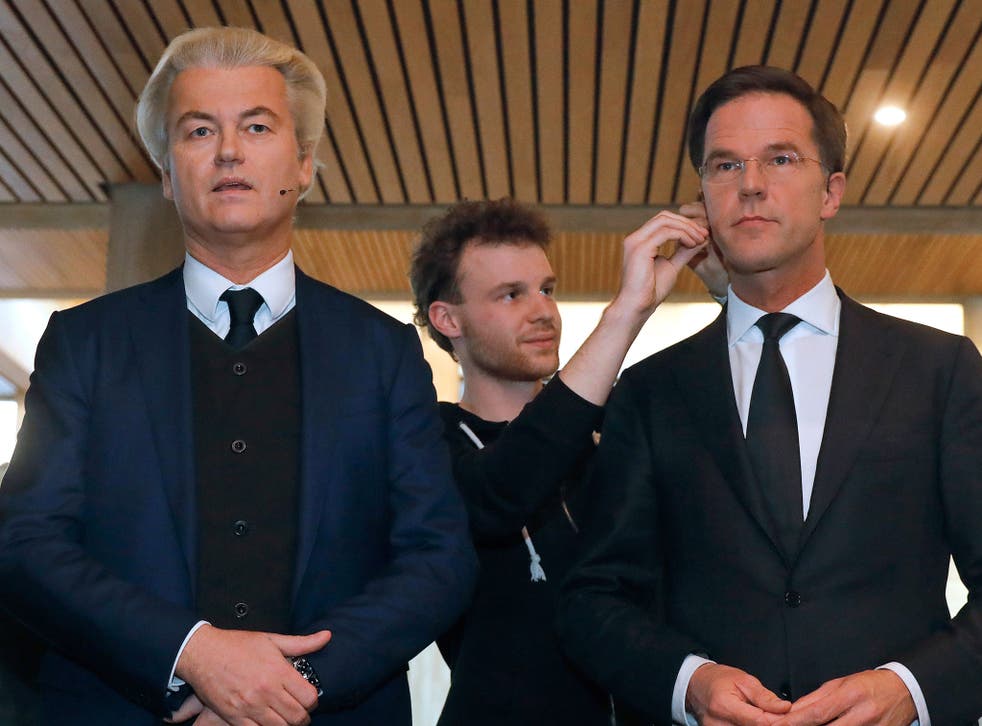 Geert Wilders and Mark Rutte get their microphones installed before the televised debate