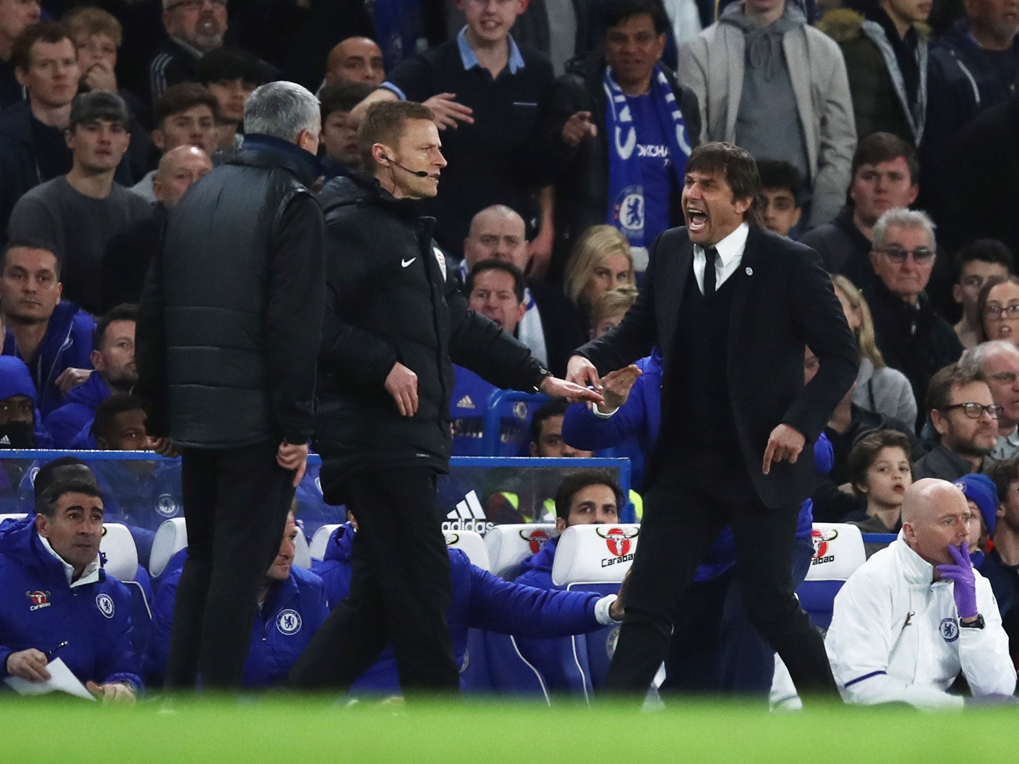 Antonio Conte and Jose Mourinho look to confront one another on the sideline