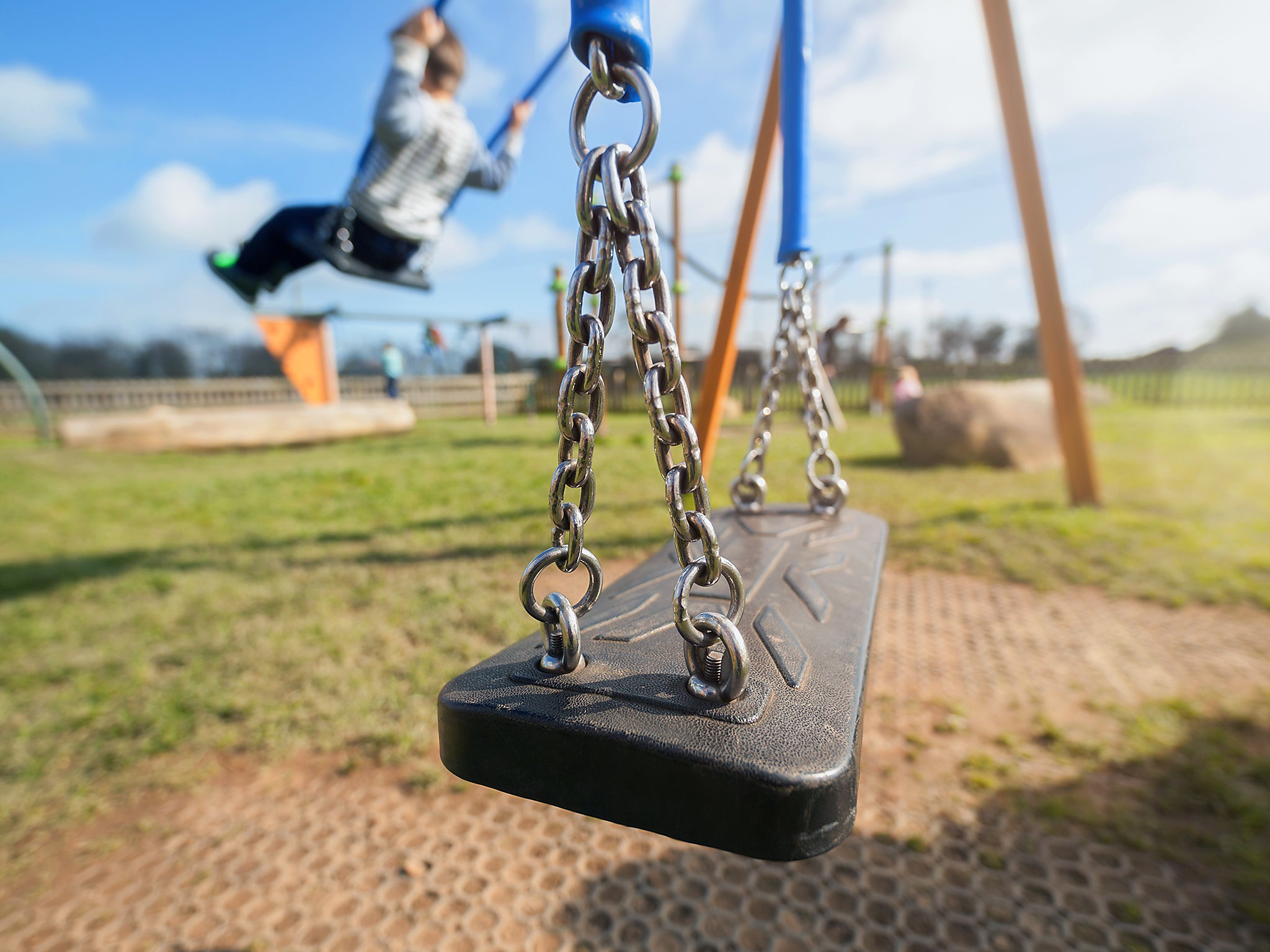 Child playing on swings