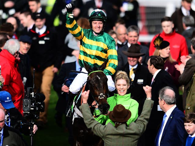 Noel Fehily on board Buveur D'air celebrates after winning the Stan James Champion Hurdle Challenge Trophy during Champion Day of the Cheltenham Festival