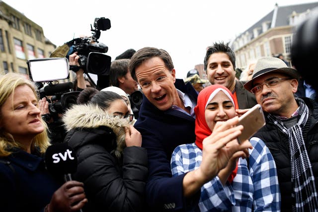 Dutch Prime Minister Mark Rutte of the VVD Liberal party greets supporters during campaigning in The Hague