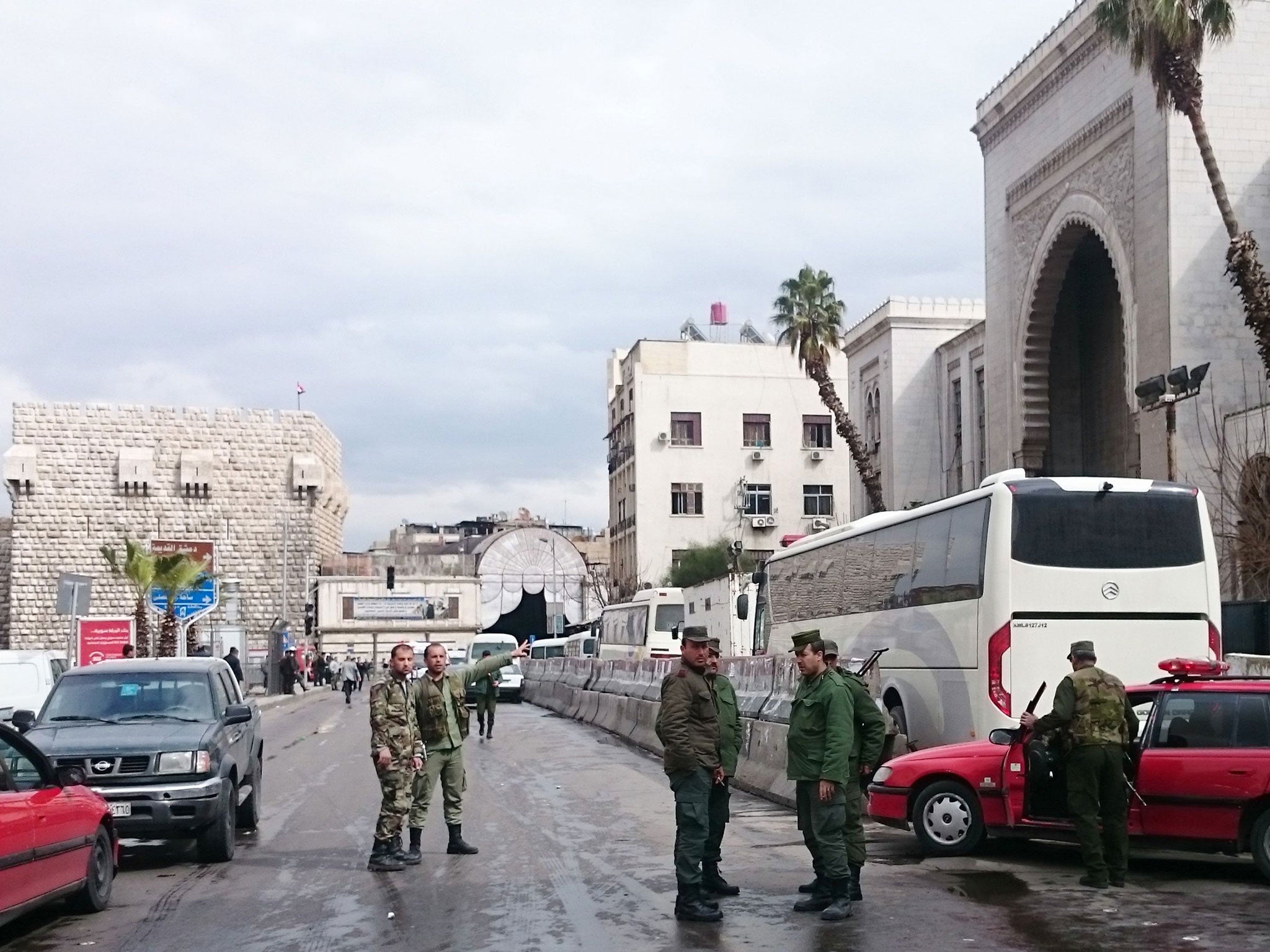 Syrian security forces cordon off the area following a suicide bombing at the Palace of Justice building in Damascus on 15 March