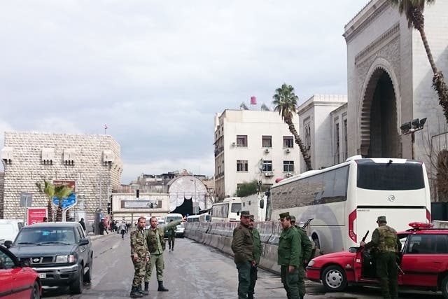 Syrian security forces cordon off the area following a suicide bombing at the Palace of Justice building in Damascus on 15 March