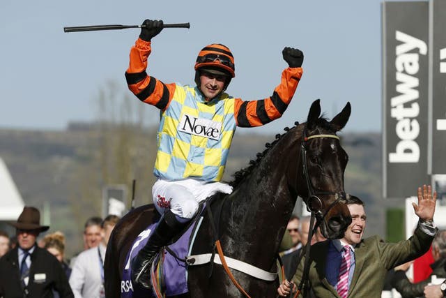 Nico De Boinville celebrates after riding Might Bite to victory in the RSA Novices' Chase