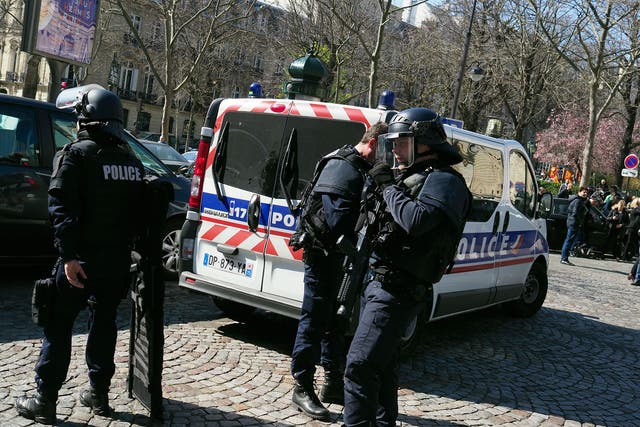 French police officers take position after a parcel bomb exploded at the French office of the International Monetary Fund in Paris on 16 March