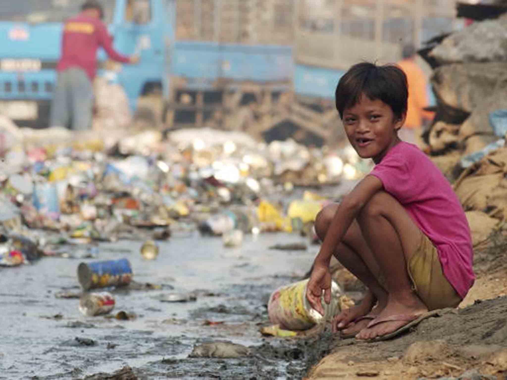 &#13;
A young student waits for classes to begin at a free school in one of the poorest neighbourhoods which surrounds Metro Manila's largest landfill in Payatas, Philippines &#13;
