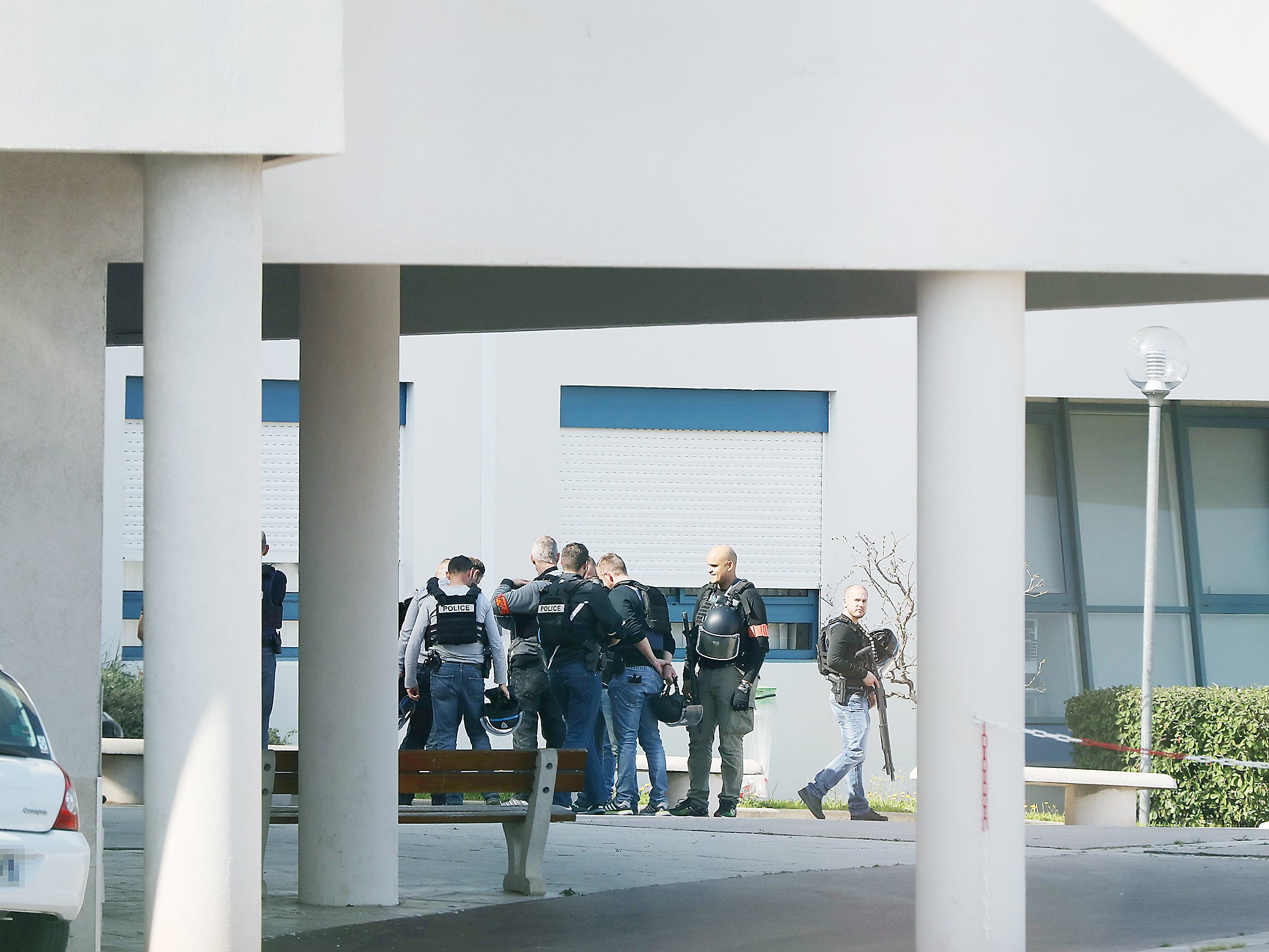 French policemen stand at the Tocqueville high school in the southern French town of Grasse