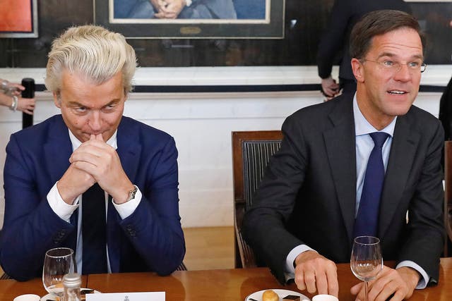 Dutch Prime Minister Mark Rutte (R) of the VVD Liberal party and Dutch far-right politician Geert Wilders of the PVV Party