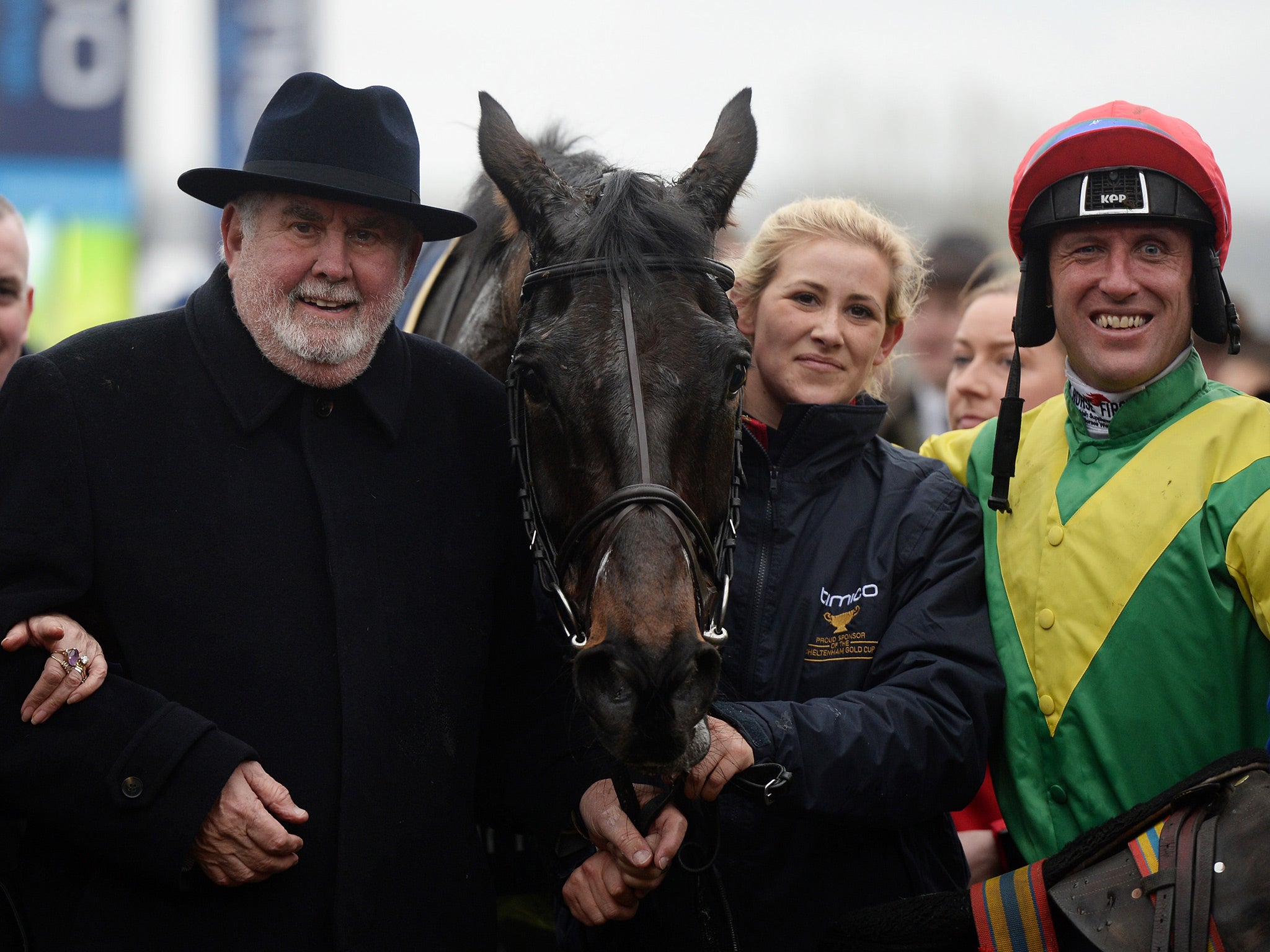 Alan Potts, left, poses with his victorious horse Sizing John and jockey Robbie Power
