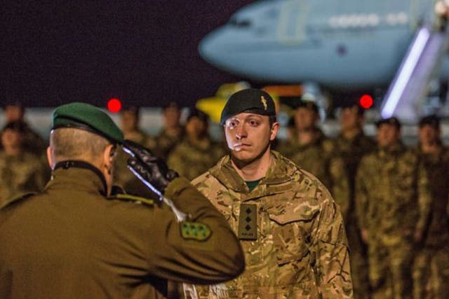UK soldier receiving a salute as troops arrive at the Amari airbase, 25 miles south-west of Tallinn
