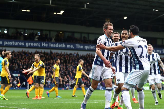 Craig Dawson is mobbed after scoring his second for West Brom